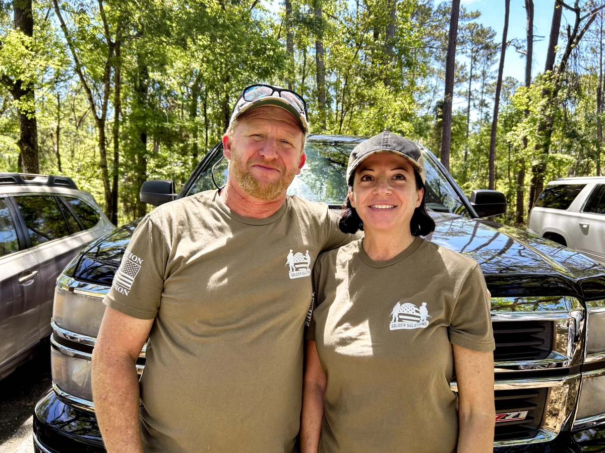 Chris Campbell, 49, maintains power lines; his girlfriend Angie Sutton, 46, is an auditor and retired from the Air Force. They were interviewed in Suwannee River State Park in Florida, wearing T-shirts that read “The People ARE PISSED OFF.”
