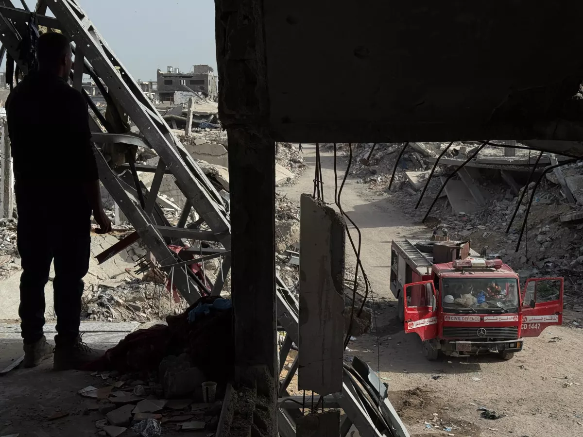 Palestinian recovery crews work to recover bodies buried under the rubble of the Abu Naser family's apartment building, destroyed in an Israeli strike in October 2024 in northern Gaza.