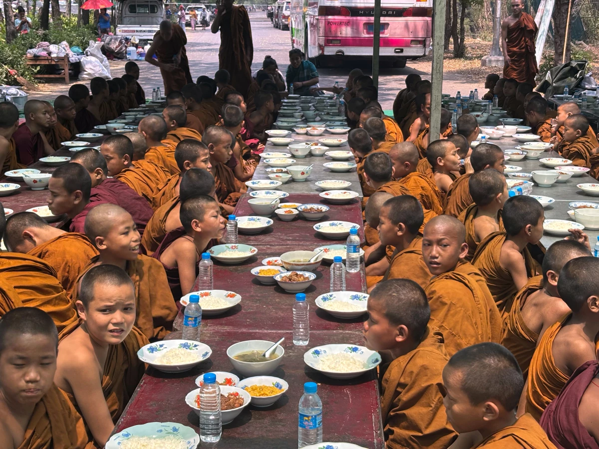 Buddhist novice monks sit under temporary shelter near a road, in the aftermath of Friday's earthquake in Mandalay, Myanmar on Wednesday.