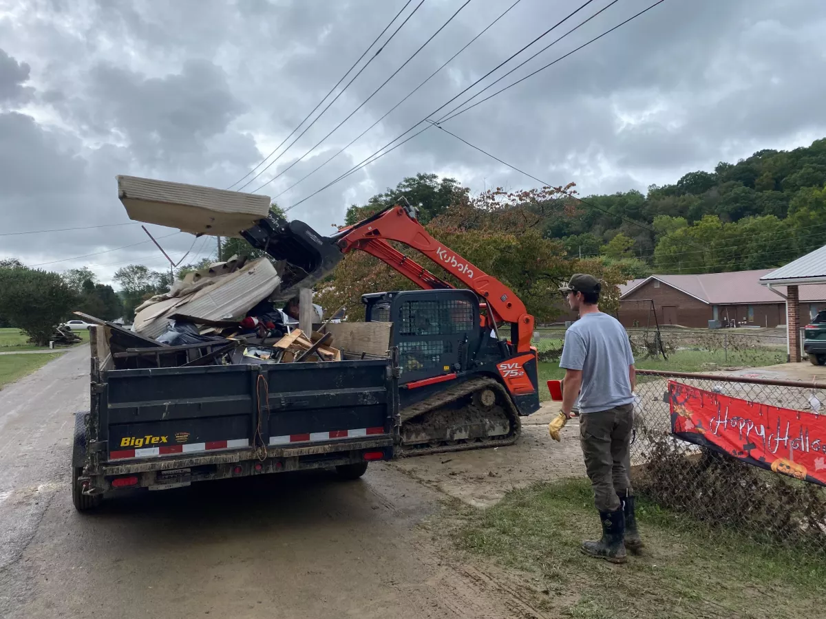 Tyler Venerable operating a forklift at Trudy Hall's home. He and his colleague will haul her belongings to the dump.