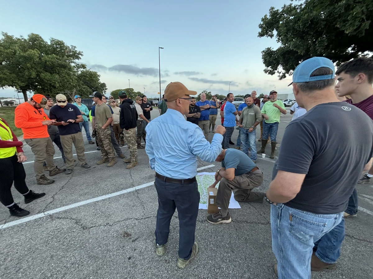 Thad Heartfield's son, Aidan, was lost in the flood in Kerr County with three other friends. Since then, he's led a search effort (center, blue shirt) to recover flood victims.