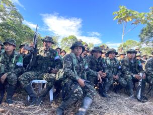 Rebels from the Comandos de la Frontera, or Border Commandos stand waiting to disarm and hand over their weapons during a rare demobilization ceremony in southern Colombia.