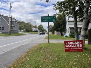 A campaign sign sits on a lawn along U.S. Route 1 in Aroostook County, Maine.