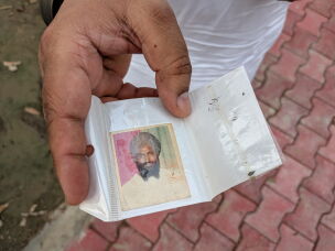 Ranjit Singh Babbar shows a photograph of his father, Atma Singh, who he says was abducted and killed by the Punjab police in 1990.<br>