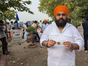 Ranjit Singh Babbar shows a photograph of his father, Atma Singh, who he says was abducted and killed by the Punjab police in 1990.<br>
