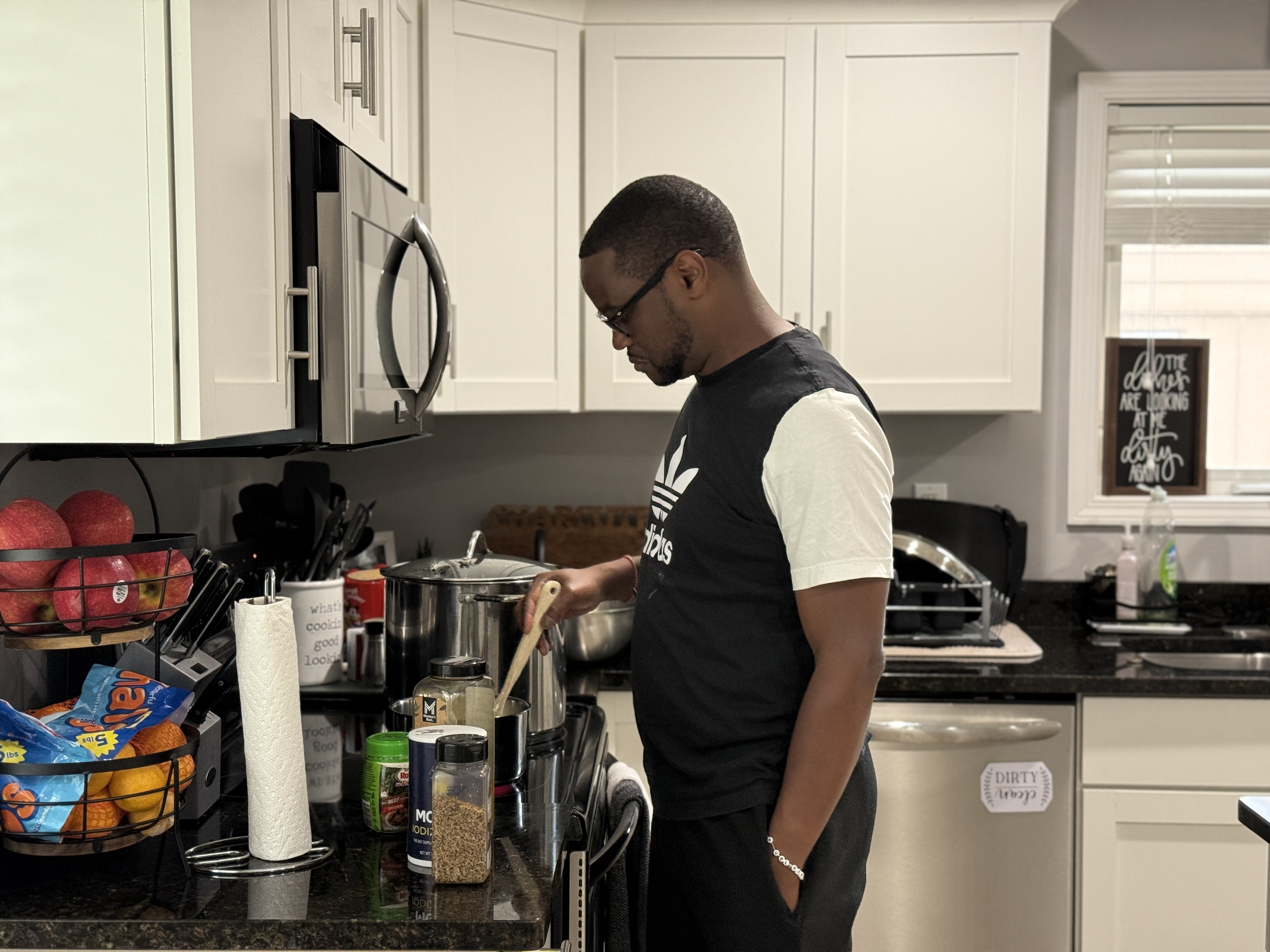 Samuel Kangethe cooks in his home on July 3 in Lansing, Michigan.