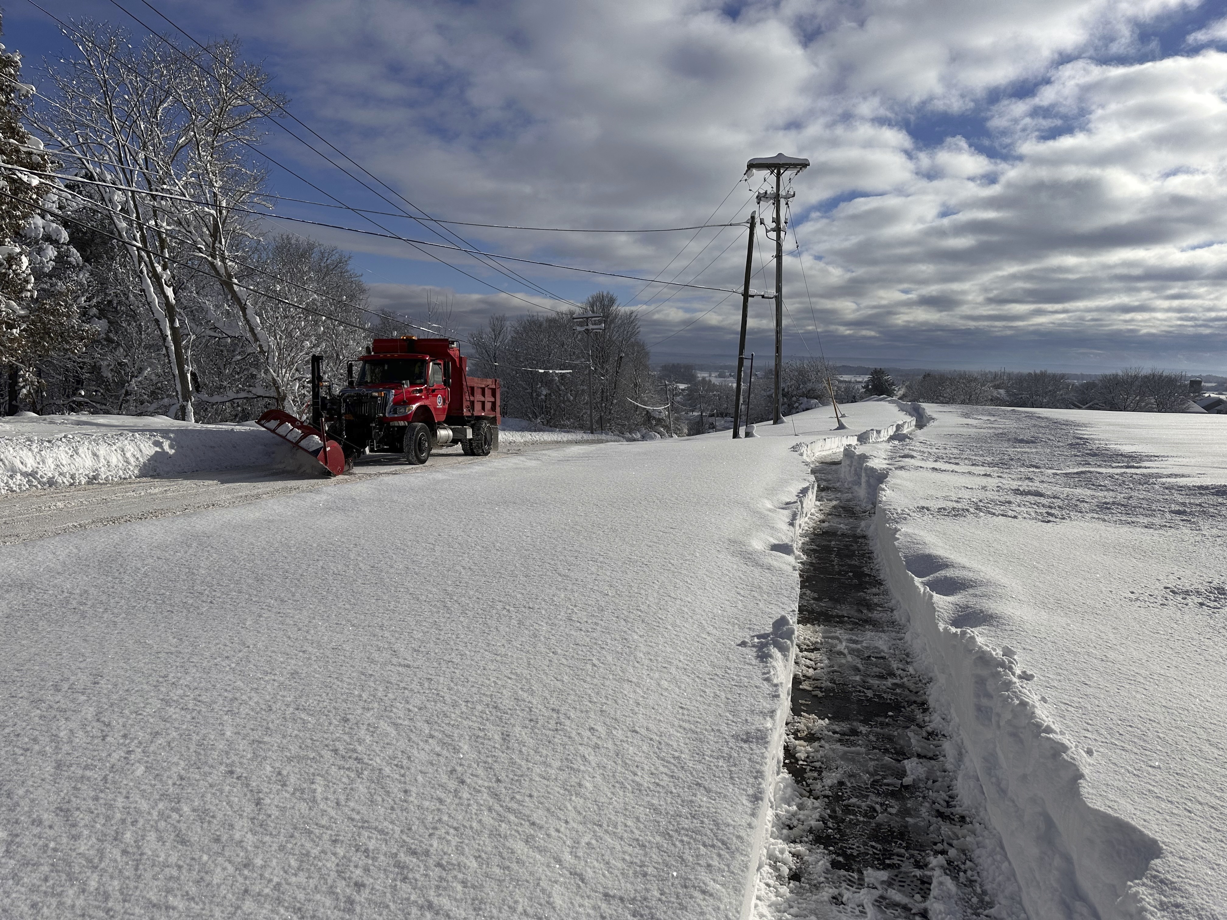 A snowplow on rounds in Lowville, N.Y., on Monday, Dec. 2, 2024. The region is cleaning up after feet of snow. (AP)