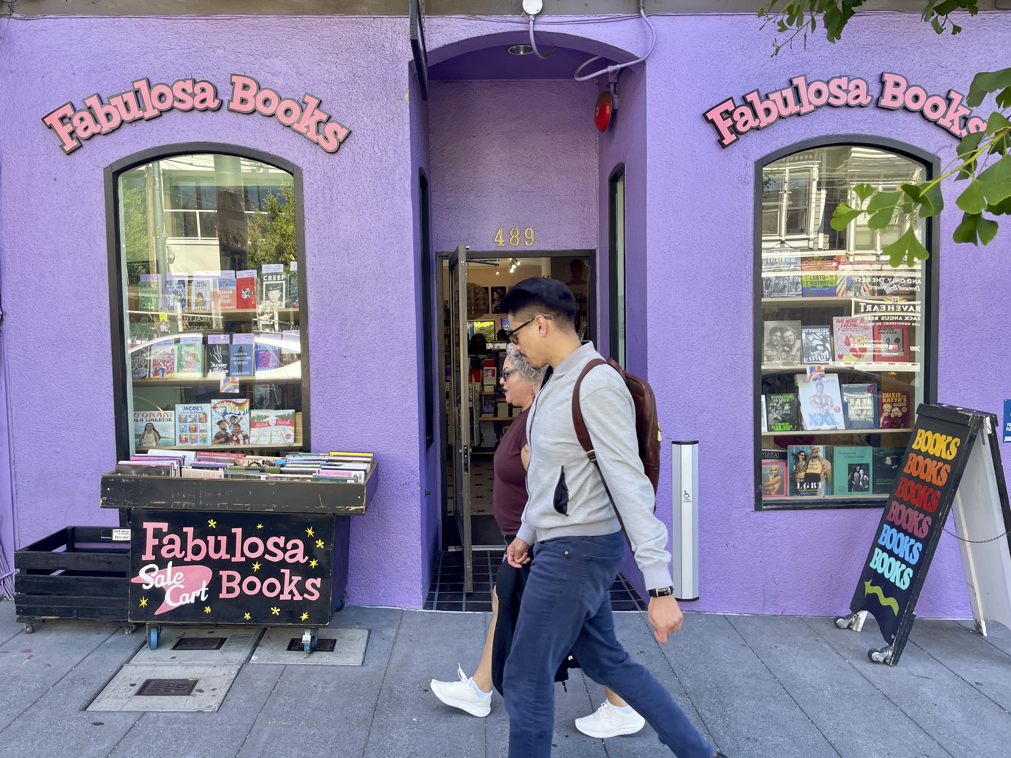 Pedestrians walk past the Fabulosa Books store in San Francisco