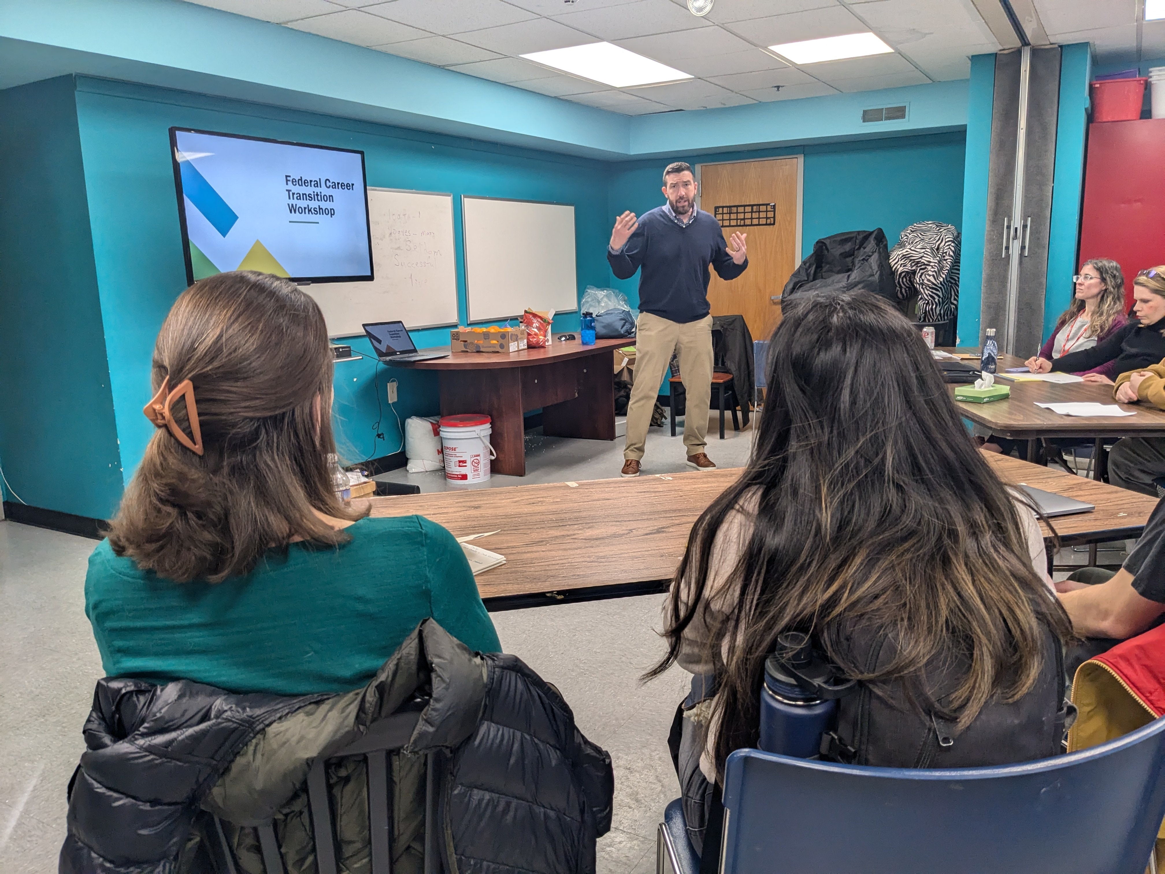 Workshop organizer Charlie Elison talks to newly laid off federal workers gearing up for the job hunt.