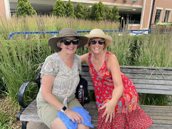 Nancy Lockhart (right) poses for a photo on a bench near the farmers market in Rochester, Mich. Lockhart says the debate reinforced her reservations about Biden’s age and she is waiting for another candidate to run in his place.