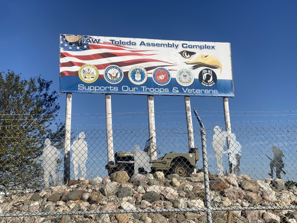 A restored World War II era Jeep sits outside the Stellantis Jeep plant in Toledo, Ohio, part of a Veterans memorial.