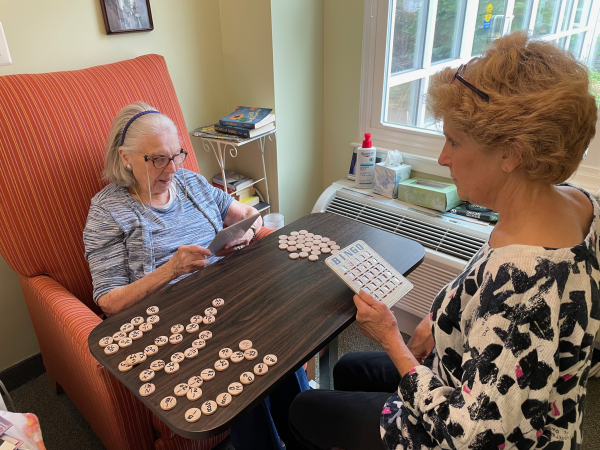 Rita Orr, 94, and her daughter Janice Rogers sit across a small table from each other to play Bingo.
