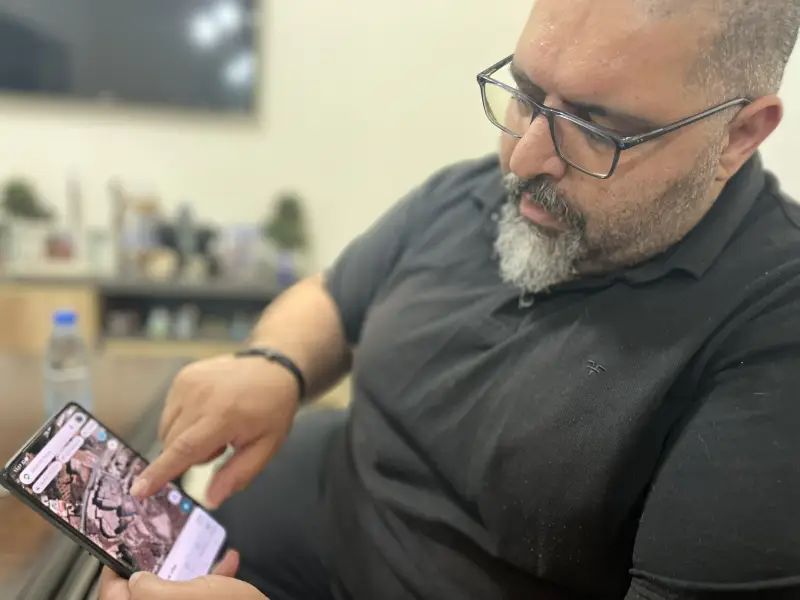 Mazen Farah points to location of the convent on his phone.