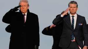 President Donald Trump and Defense Secretary Pete Hegseth salute as carry teams move the transfer cases with the remains of Iowa National Guard soldiers Sgt. William Nathaniel Howard, 29, of Marshalltown, Iowa, and Sgt. Edgar Brian Torres-Tovar, 25, of Des Moines, Iowa, and civilian interpreter Ayad Mansoor Sakat, who were killed in an attack in Syria, during a casualty return, Wednesday, Dec. 17, 2025 at Dover Air Force Base, Del.