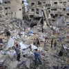 Palestinians search among rubble, damaged tents and household belongings after an Israeli airstrike in the Al-Nasr neighborhood of western Gaza City, on July 30, 2026. The overnight strike hit the Matter family home and destroyed the residential building and the nearby Al-Zuhour displacement camp, where local authorities said around 35 displaced families had been sheltering.