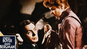 A movie poster for the 1944 film, Gaslight, starring Ingrid Bergman and Charles Boyer. Bergman is holding a knife toward Boyer's face and he's tied to a chair.