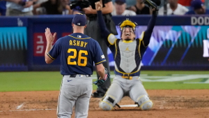 Milwaukee Brewers pitcher Aaron Ashby (26) and catcher William Contreras celebrates after the final out of Game 4 of baseball's National League Championship Series between the Milwaukee Brewers and the Los Angeles Dodgers, Thursday, Oct. 15, 2026, in Los Angeles. (AP Photo/Mark J. Terrill)