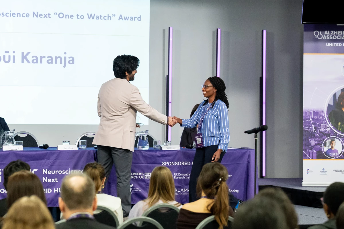 Wambūi Karanja of Kenya accepts the 'One to Watch' award from the Alzheimer's Association for the guide she's developed to help family caregivers.