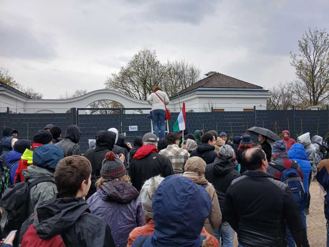 Sightseers climb a ladder to see onto the grounds of Viktor Orbán's family’s estate.