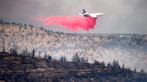 An air tanker drops retardant while battling the Bench fire on Saturday, July 25, 2026, in Jefferson County, Ore.