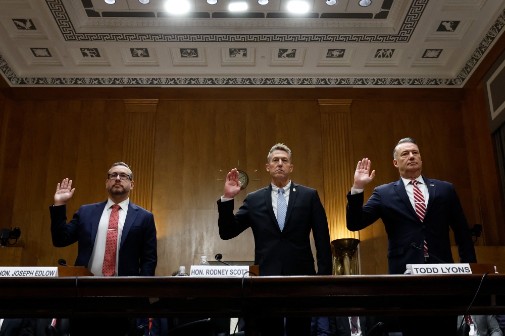From left, Director of USCIS Joseph Edlow, Customs and Border Protection Commissioner Rodney Scott and Acting Director of Immigration and Customs Enforcement Todd Lyons are sworn in Thursday to testify during a hearing on oversight of the Department of Homeland Security. (AFP via Getty Images)