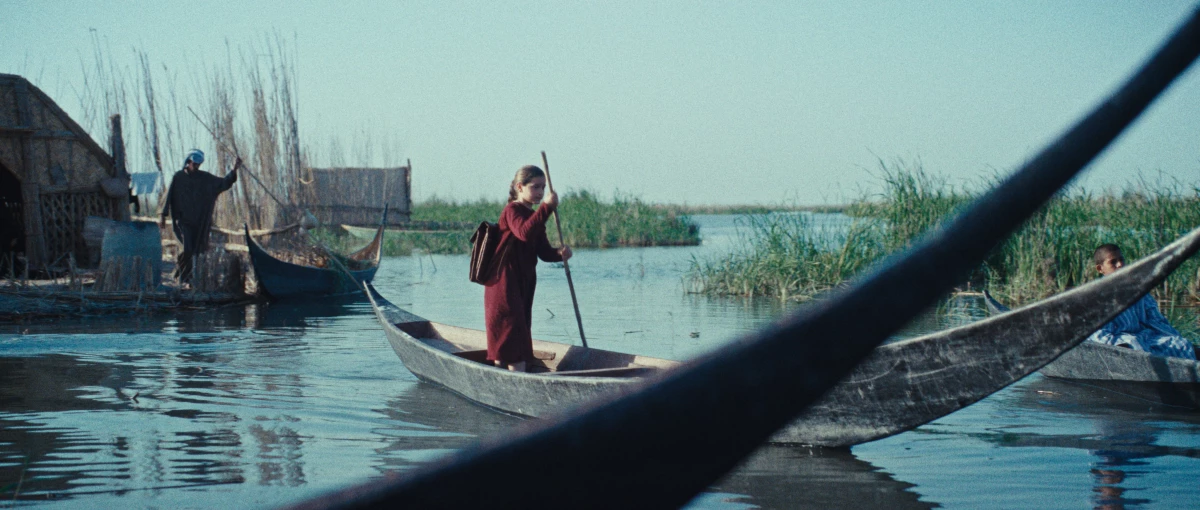 Lamia (Baneen Ahmed Nayyef) rows through Mesopotamian marshlands from her home to school.