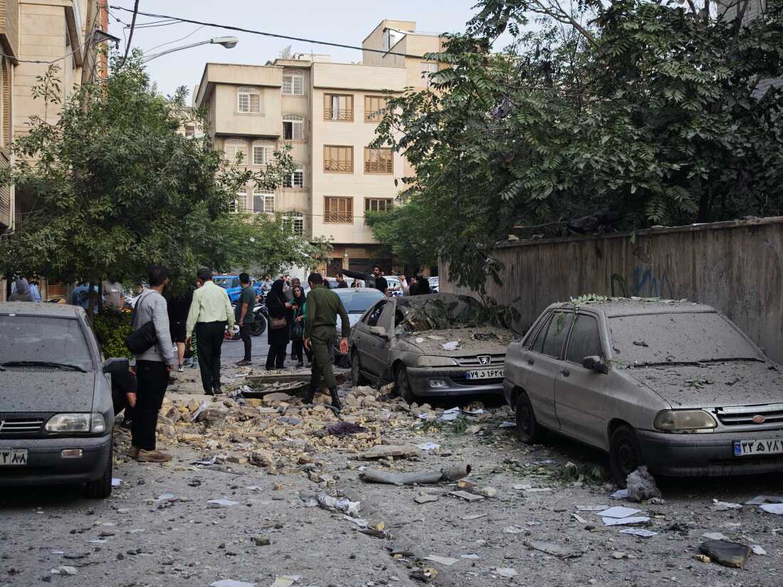 TEHRAN, IRAN - JUNE 13: People look over damage to buildings following Israeli airstrikes on June 13, 2025 in Tehran, Iran. Iran's three top military generals were killed in the attacks that also targeted nuclear and military facilities, according to published reports. Israel described the strikes as preemptive to keep Iran from obtaining nuclear weapons, the reports said. (Photo by Majid Saeedi/Getty Images)