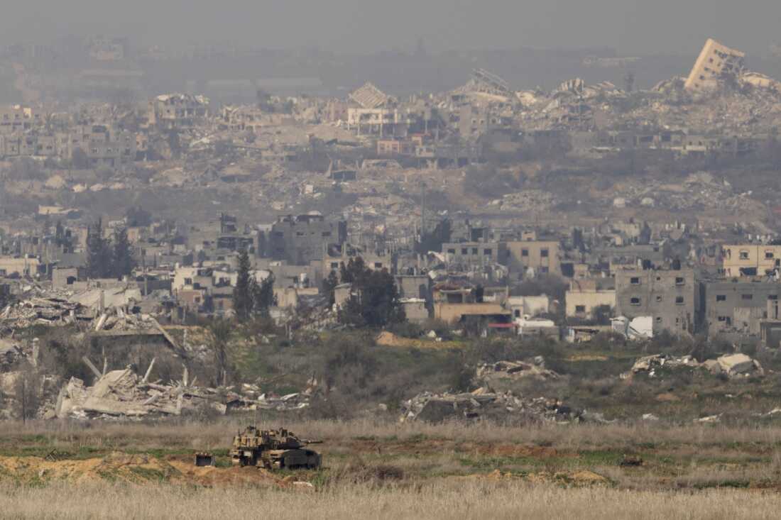An Israeli tank stands in position in the northern Gaza Strip as seen from a the Israeli side of the border on January 28, 2025 in Southern Israel, Israel.