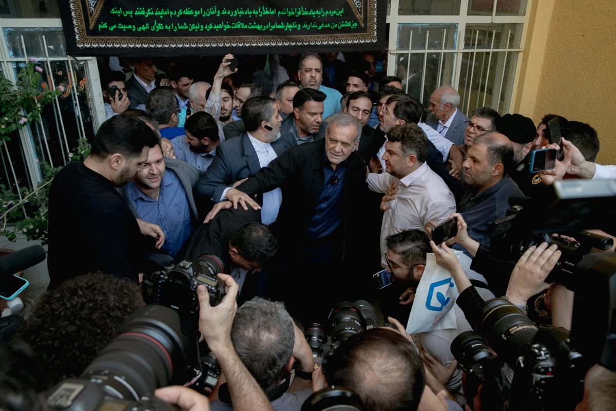 Masoud Pezeshkian, one of the two candidates qualifying for the second round of the Iranian presidential election, arrives at a polling station to cast his vote in Tehran on Friday.