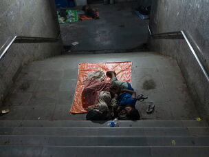 A family sleeps inside a subway near the All India Institute of Medical Sciences in New Delhi, India. Many families who don't have a place to stay sleep in public spaces near the hospital.