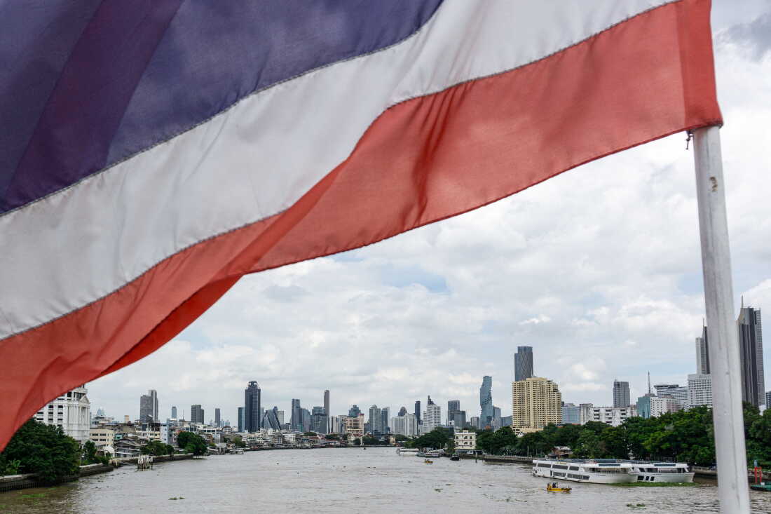 A national flag of Thailand flutters in the wind with the city skyline in the background in Bangkok on September 9, 2026.