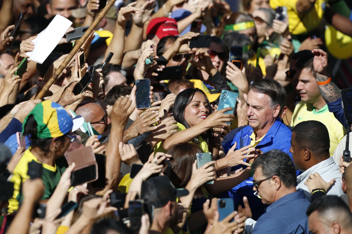 Brazil's former President Jair Bolsonaro (R) greets supporters during a rally on Paulista Avenue in Sao Paulo, Brazil, on June 29.