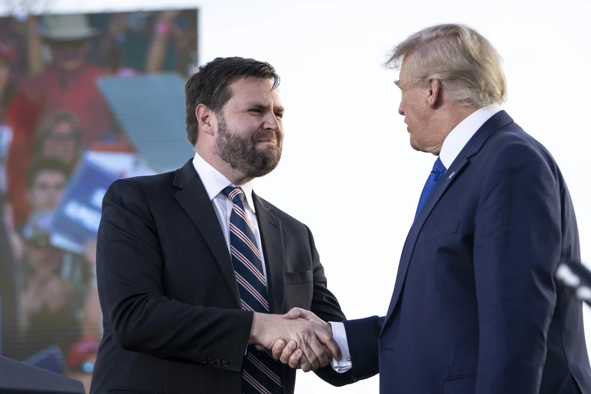 JD Vance shakes hands with Donald Trump during a rally hosted by the former president at the Delaware County Fairgrounds in April 2022.