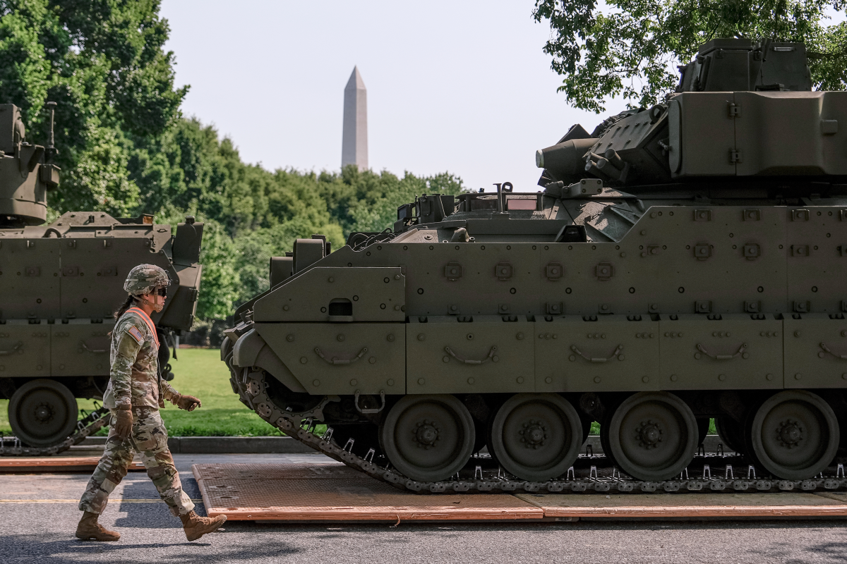 A U.S. Army soldier walks past a Bradley fighting vehicle staged in West Potomac Park ahead of an upcoming military parade commemorating the Army's 250th anniversary and coinciding with Donald Trump's 79th birthday,  June 11, 2025, in Washington.