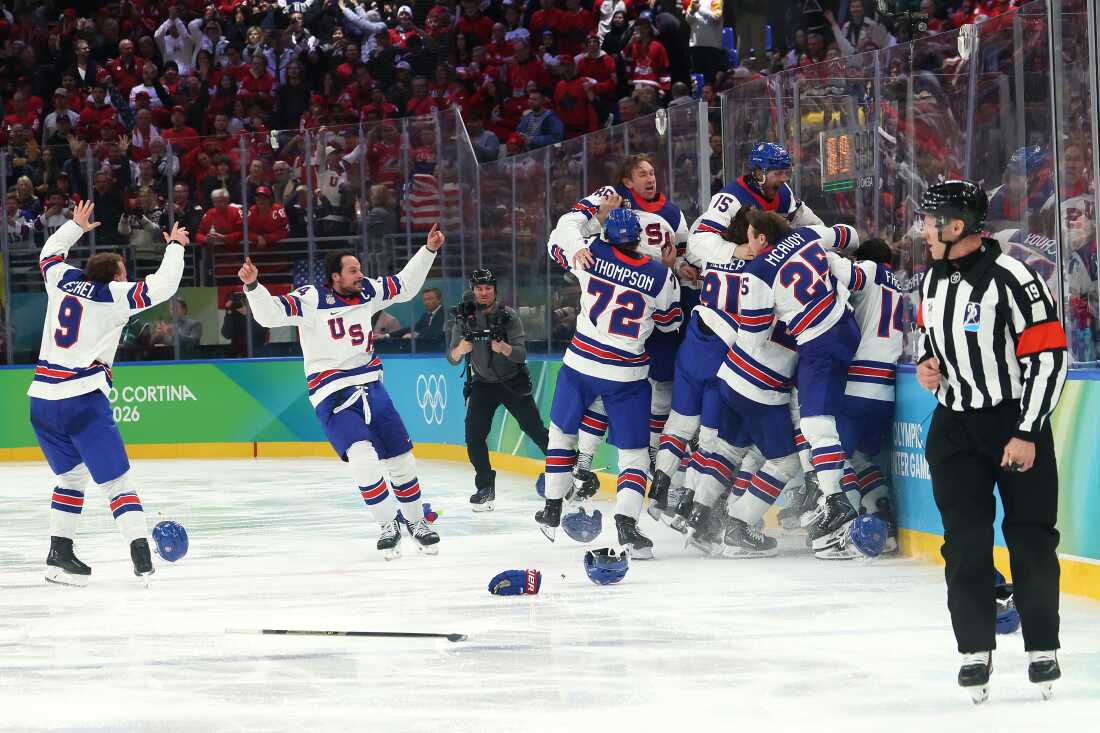 MILAN, ITALY - FEBRUARY 22: Jack Hughes #86 of Team United States celebrates with teammates after scoring the game-winning goal in overtime during the Men's Gold Medal match between Canada and the United States on day 16 of the Milano Cortina 2026 Winter Olympic games at Milano Santagiulia Ice Hockey Arena on February 22, 2026 in Milan, Italy.
