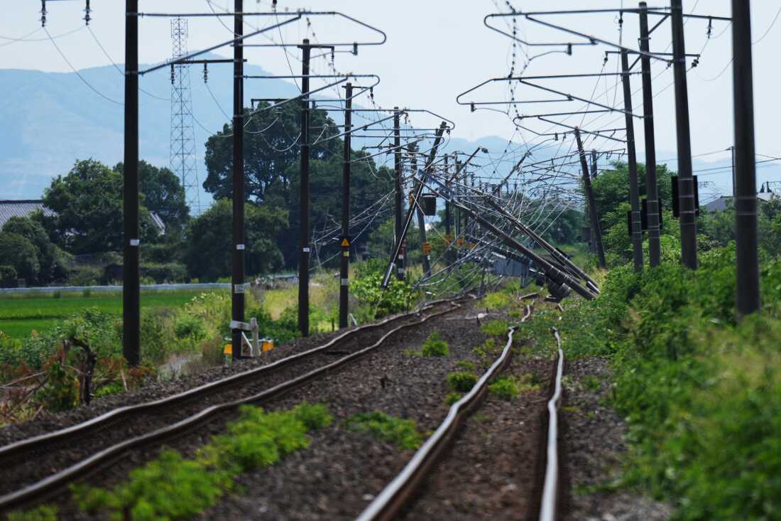 Electric poles are seen fallen over rail tracks in Hikawa, southern Japan, Thursday, July 30, 2026, two days after an earthquake hit the area.