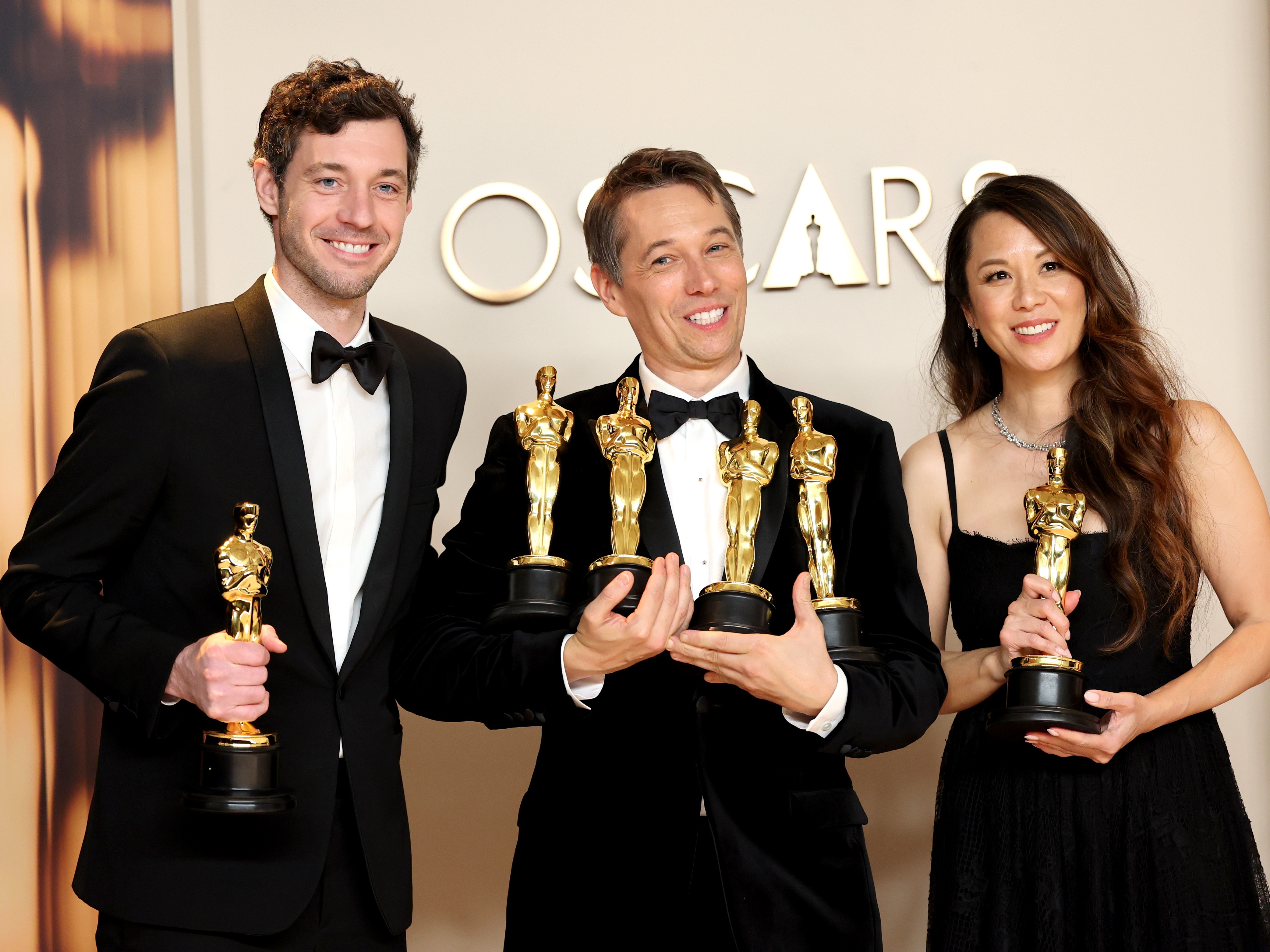 Alex Coco, left, Sean Baker and Samantha Quan pose in the press room with their Oscars for <em>Anora.</em> Best picture winner 'Anora' is an indie film — what does that mean?