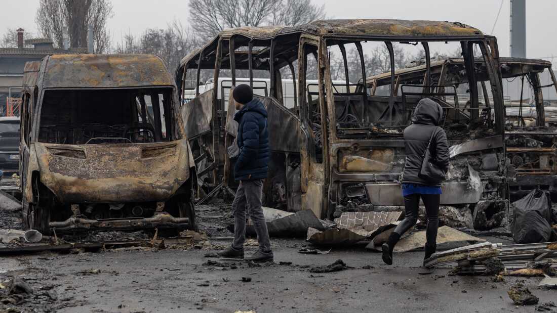Local residents inspect damaged cars at the site of a Russian attack in Odesa on Feb. 13, amid the Russian invasion of Ukraine.