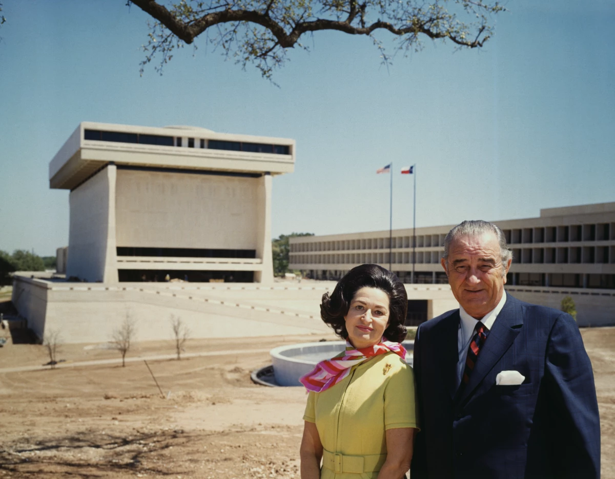 Former President and Mrs. Lyndon B. Johnson stand before the Lyndon B. Johnson Library on the University of Texas campus.