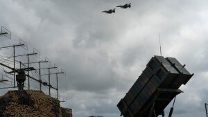 Ukrainian Air Force F-16 fighter jets fly over a Patriot air and missile defense system in an undisclosed location in Ukraine, on Aug. 4, 2024.