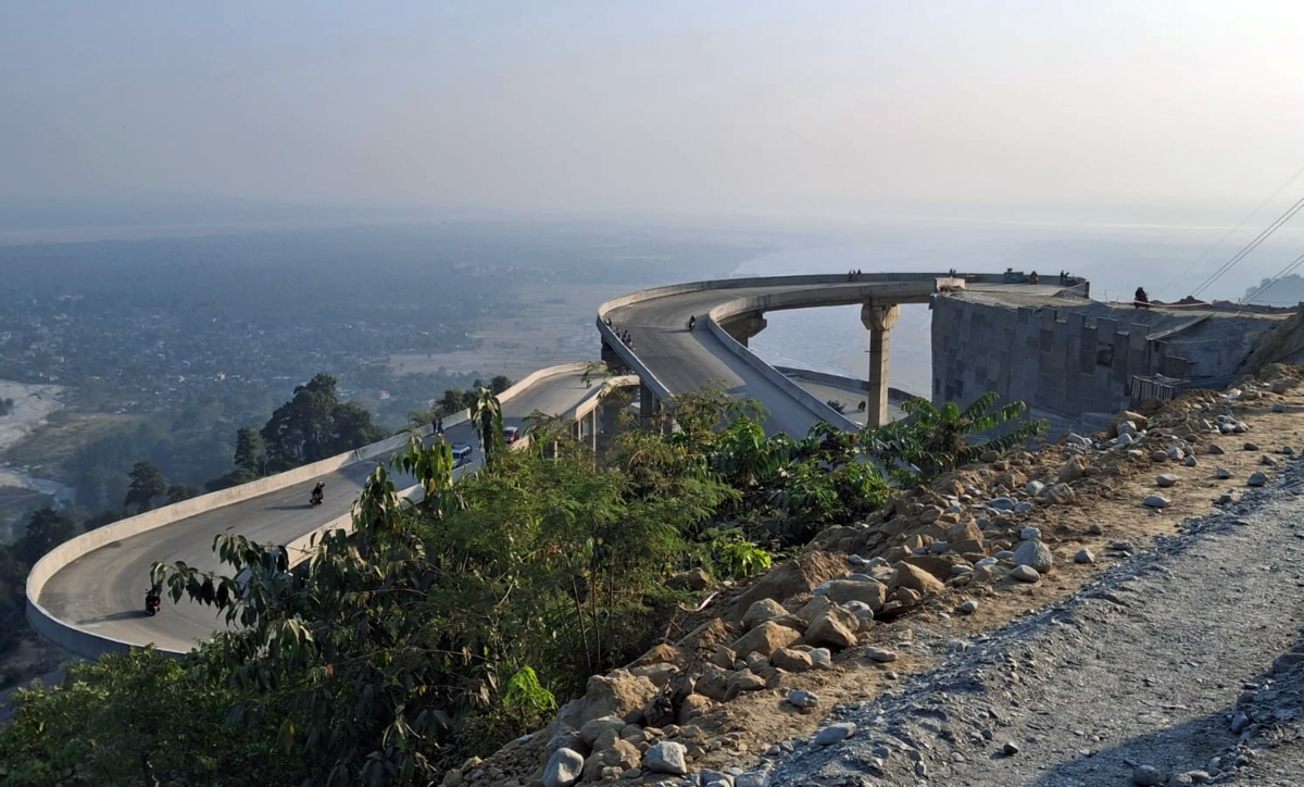 People watch and travel India's new National Highway route connecting the border state of Sikkim with West Bengal state and the rest of the country, in Bagrakote, West Bengal, India, on Jan. 6, 2025.
