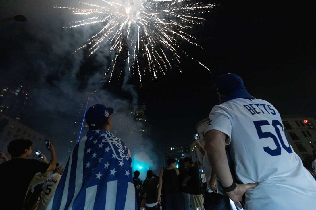 People watch as fireworks explode in Los Angeles after the Los Angeles Dodgers defeated the Toronto Blue Jays in Game 7 of baseball's World Series Sat., Nov. 1, 2025.