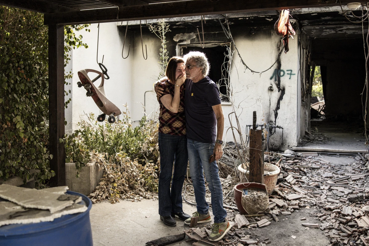Adel Rubin (L), who lost both her parents during the Oct. 7, 2023, attacks, reacts as she visits a house that was left heavily-damaged after the event in Kibbutz Nir Oz in southern Israel on October 6, 2025, a day before the second anniversary of the attacks.
