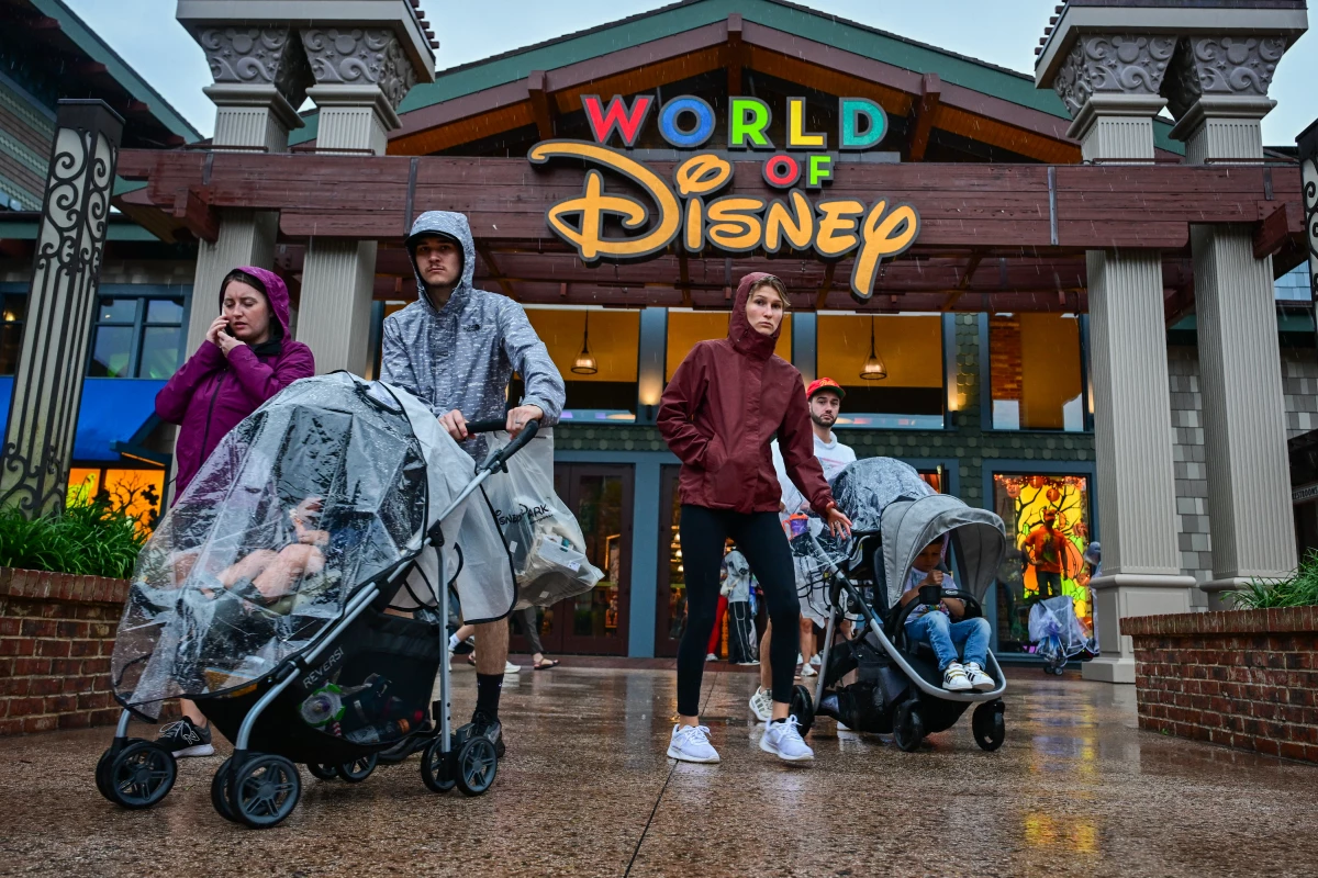 Visitors walk through the Disney Springs shopping center in Orlando ahead of Hurricane Milton's landfall in Florida on Oct. 9, 2024.