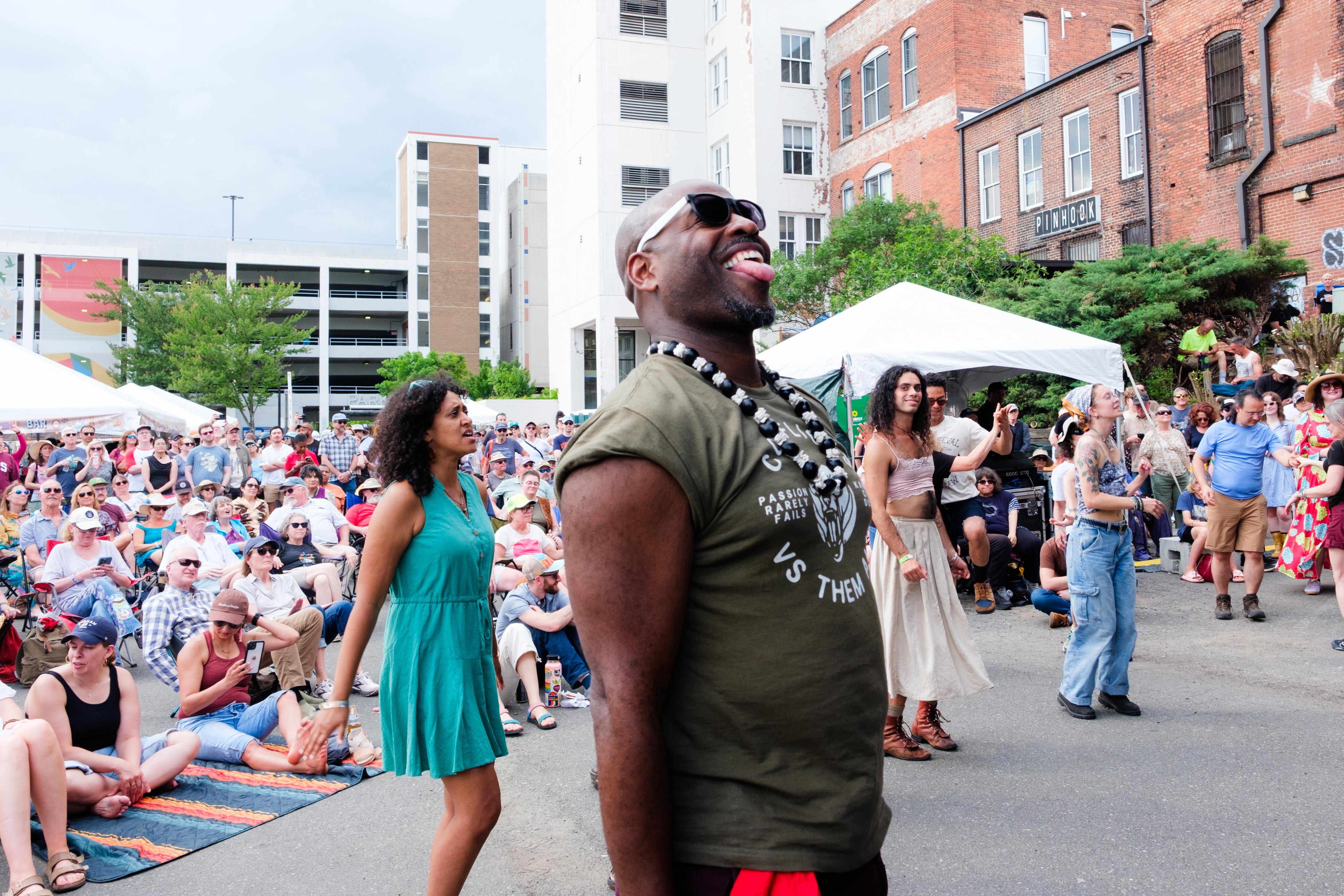 Attendees watch and dance as New Dangerfield performs during the Biscuit & Banjos festival in Durham, N.C., on April 26.