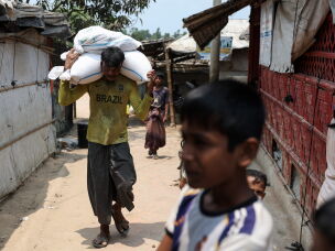 A man carries sacks on his shoulders in a Rohingya refugee camp in Cox's Bazar, Bangladesh, April 21, 2026.
