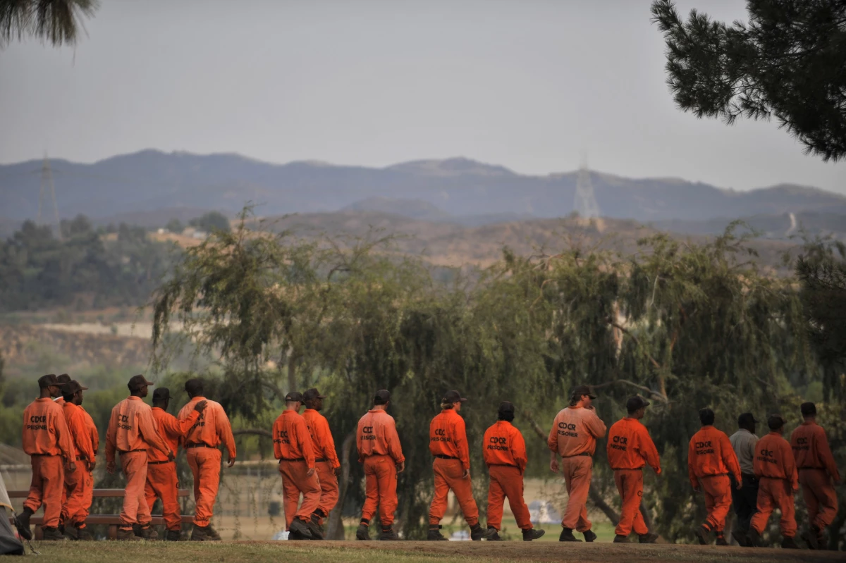 Inmate firefighters from the California Department of Corrections and Rehabilitation walk in at the Station Fire Incident Command Post in the Lake View Terrace area of Los Angeles in 2009.