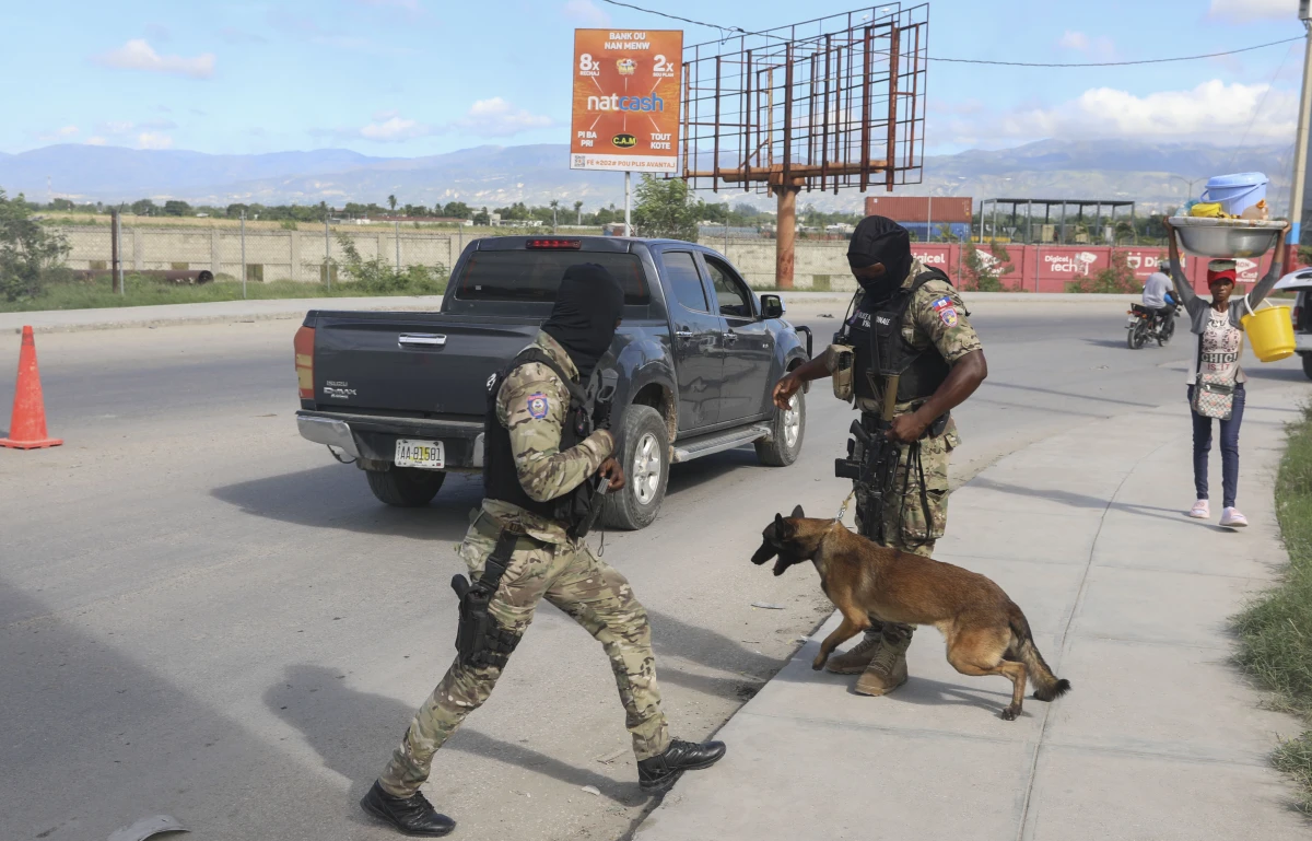 Police officers patrol near the Toussaint Louverture International Airport in Port-au-Prince, Haiti on Tuesday.