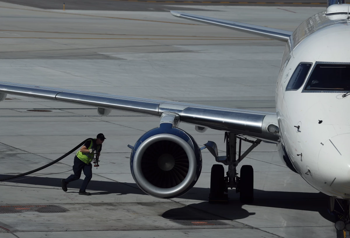 A worker fuels a Delta Airlines plane at Salt Lake City International Airport on April 09, 2026. As fuel prices continue to rise amid the war in Iran, airlines around the world are canceling flights and scaling back routes due to surging jet fuel prices.
