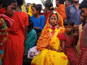 Although India has laws forbidding child marriage, there are many thousands of child marriages each year. Pictured: A 14-year-old on her wedding day.